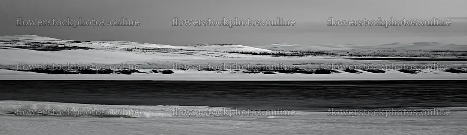 Snowy highland meadow with river in black and white – flower stock photos 14762x4268